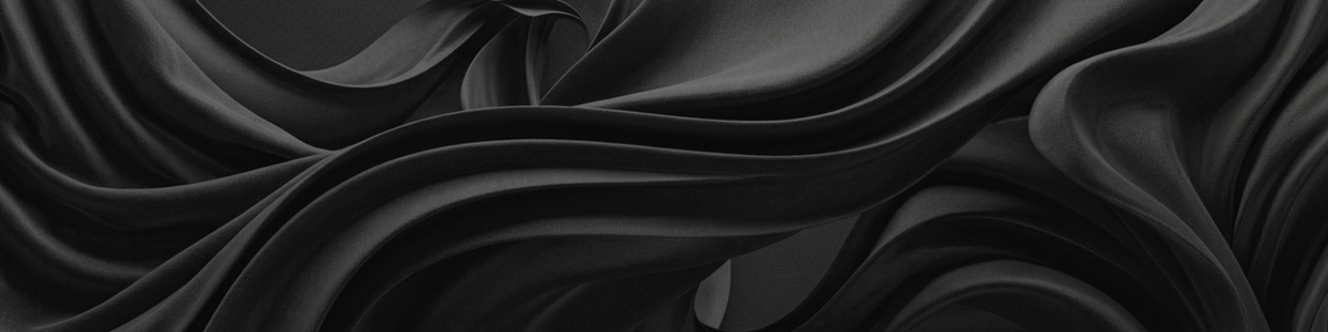 Close detail of the imported performance knit — folds of matte black four-way stretch fabric